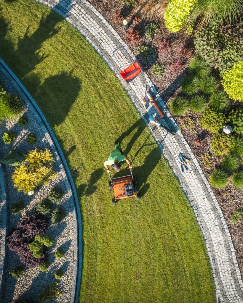 Landscaping Worker Lawn Aerating Using Gasoline Aerator